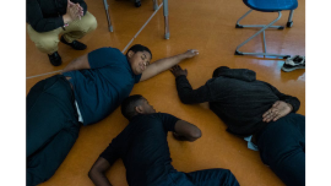 . Students relax on the floor as part of a mindfulness exercise led by Cruz.