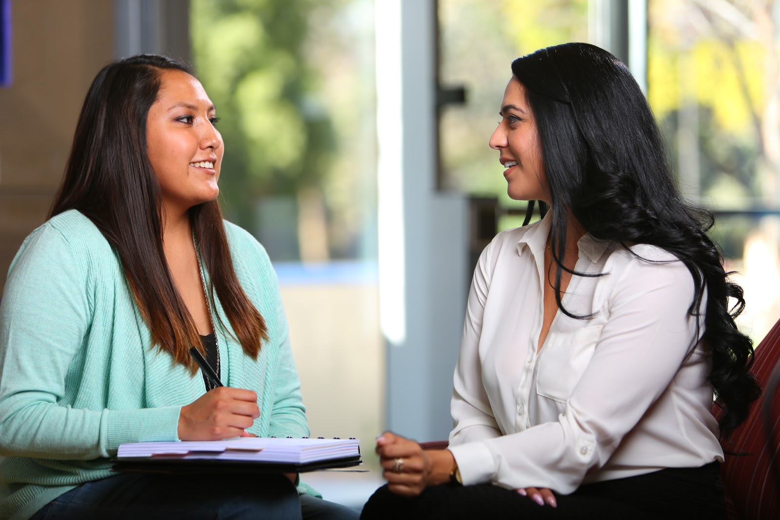 Adviser Myrna Cardenas converses with a student. Photo Credit: College Success Arizona