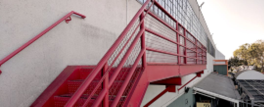 The red stairway leading to Gate 510, which houses this summer’s PilotCity fellows