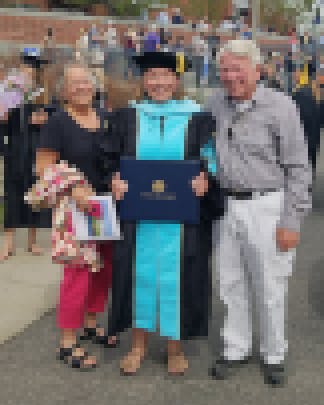 Morrison and her parents Pat and Sandy Koerner after her hooding ceremony at Montana State University in 2018.