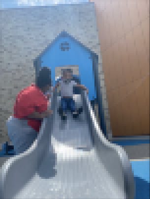 Teacher and child on slide