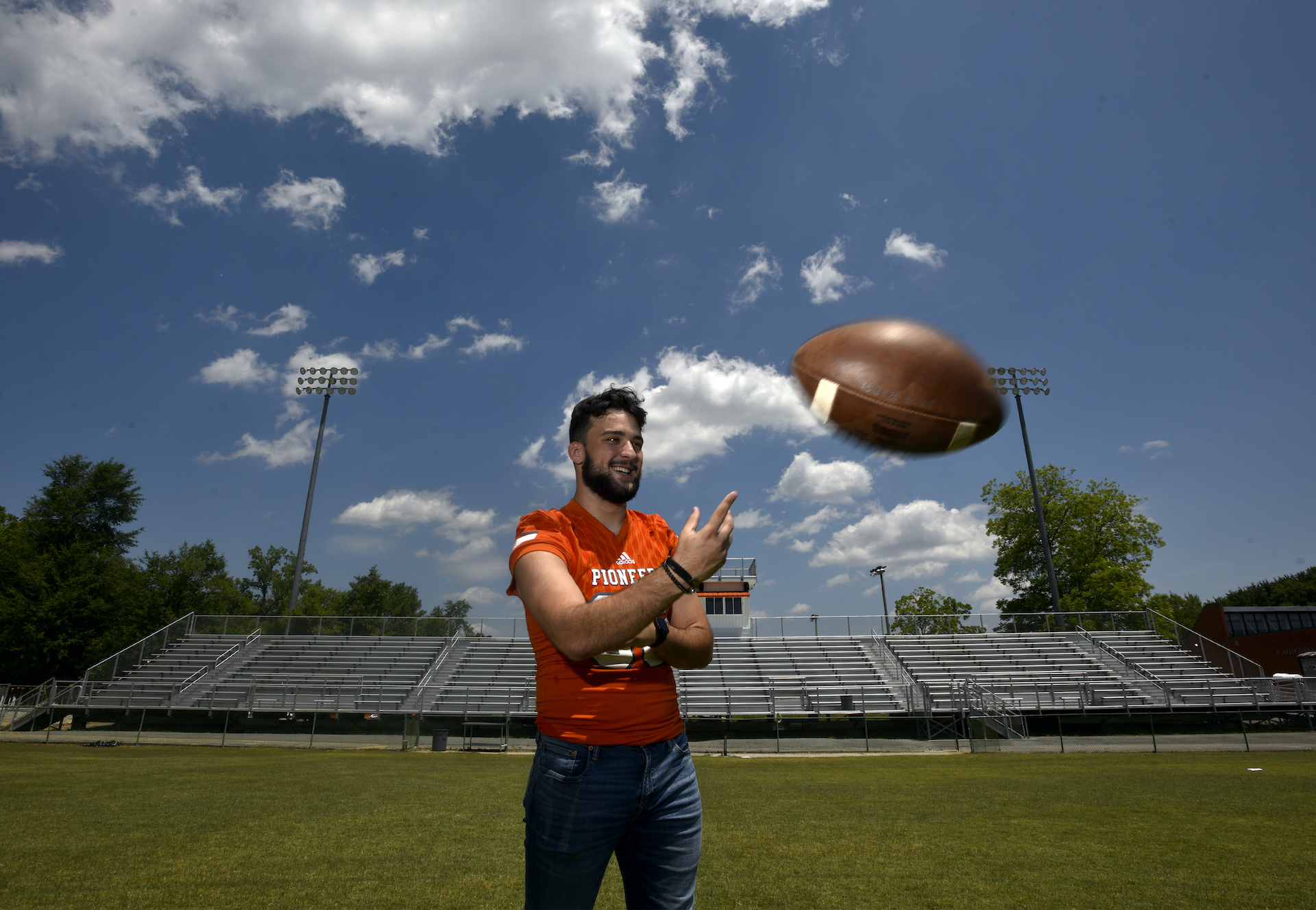 Dino throwing football