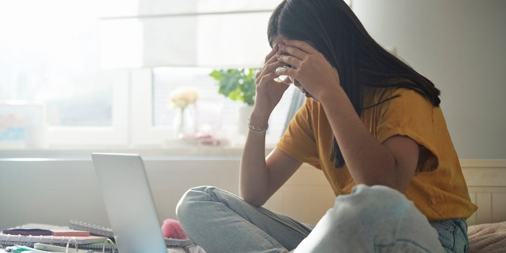 Teacher encouraging student writing effort in classroom