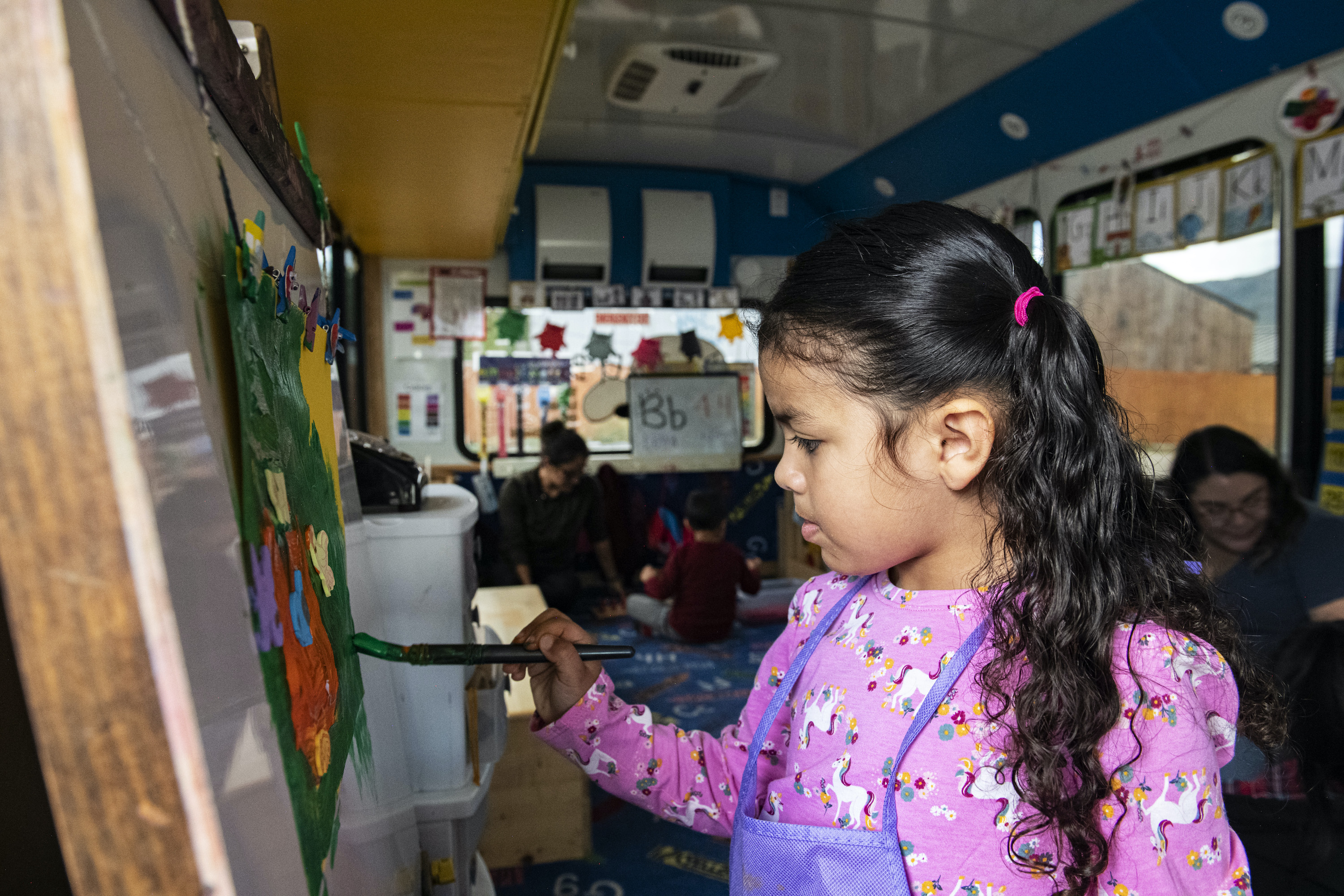 Andrea Arevalo, 4, paints a picture at the front of the El Busesito in El Jebel, Colorado on Thursday, September 29, 2022